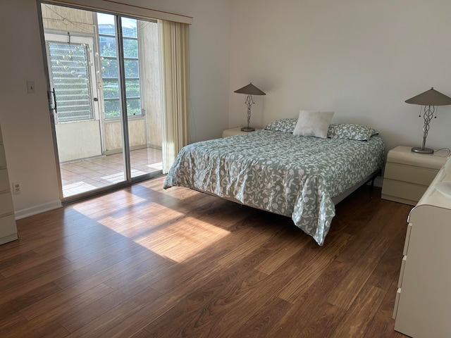 bedroom featuring hardwood / wood-style flooring and access to exterior