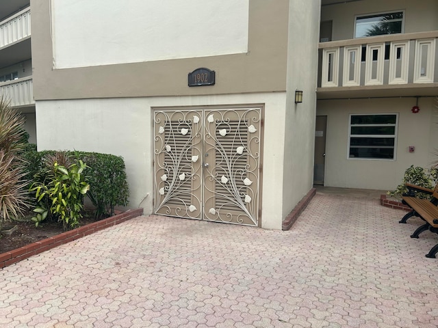 view of exterior entry with a balcony