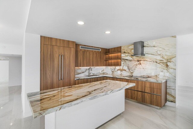 kitchen with light stone countertops, white cabinetry, a water view, and stainless steel double oven