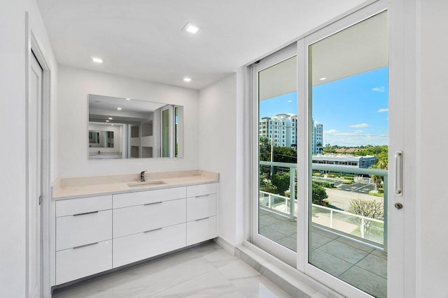 bathroom featuring vanity, a view of city, and recessed lighting