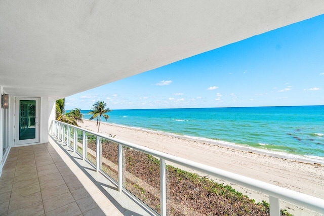 balcony with a view of the beach and a water view