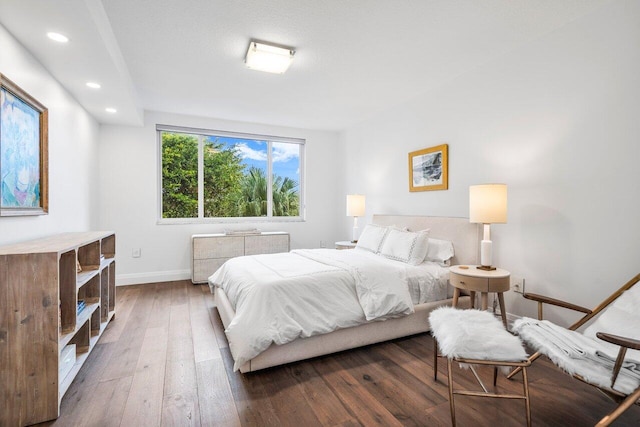 bedroom featuring dark wood-type flooring and radiator heating unit