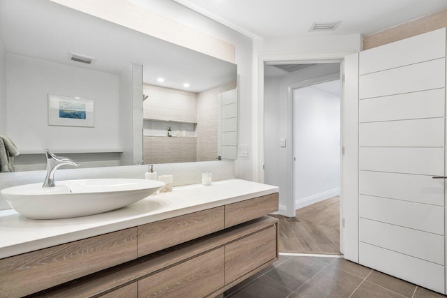 bathroom featuring a shower, tile patterned floors, and vanity