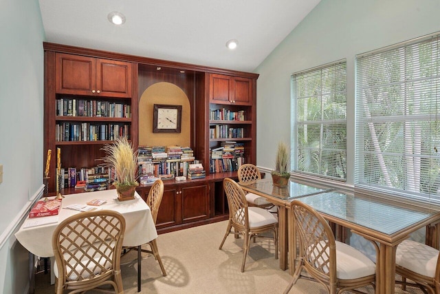 office area with lofted ceiling and light colored carpet