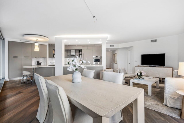 dining room with dark wood-type flooring