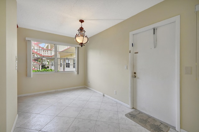 tiled entryway with a textured ceiling