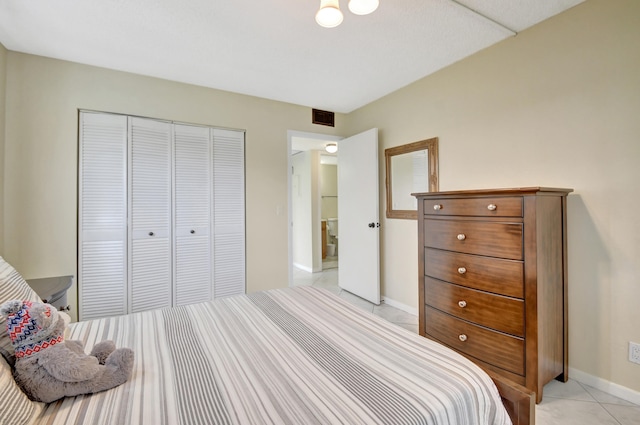 tiled bedroom featuring a closet