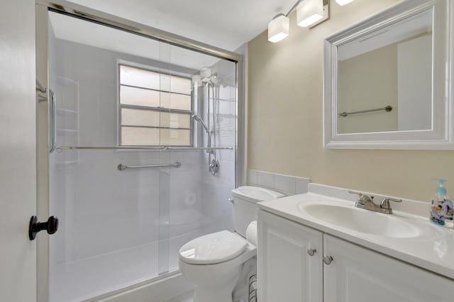 bathroom with vanity, toilet, and walk in shower