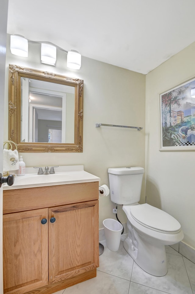 bathroom with vanity, toilet, and tile patterned floors