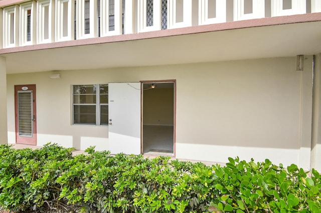 view of exterior entry featuring a balcony