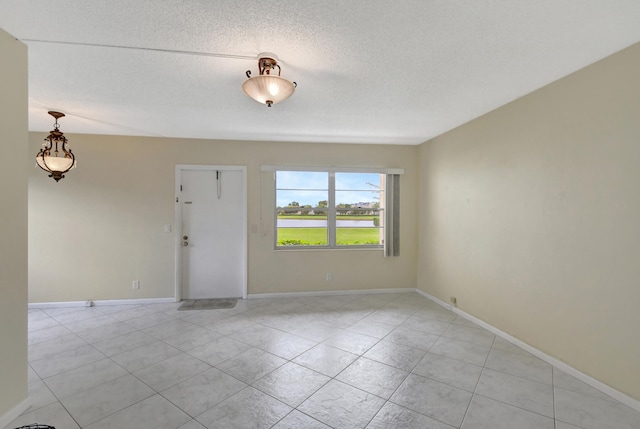 unfurnished room featuring a textured ceiling