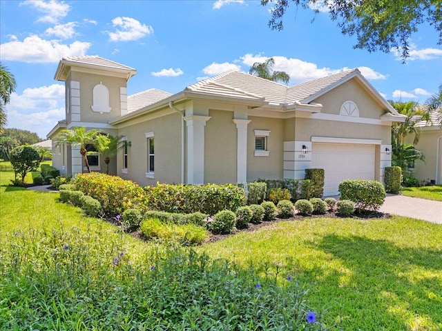 view of front of property featuring a garage and a front lawn