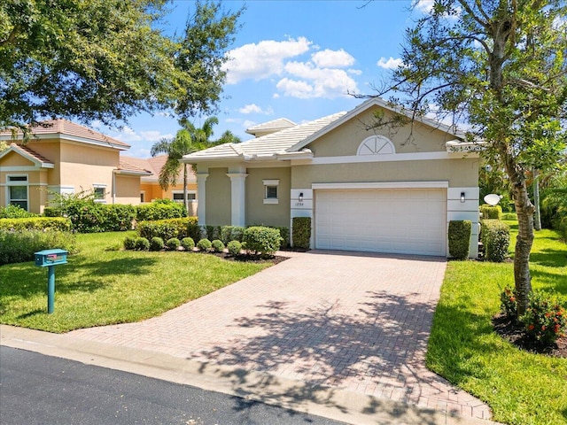 view of front of property featuring a front yard and a garage