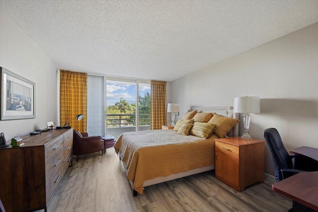 4101 N Ocean Blvd Unit D-308, Boca Raton, FL 33431 - bedroom with a textured ceiling, wood finished floors, and an office area