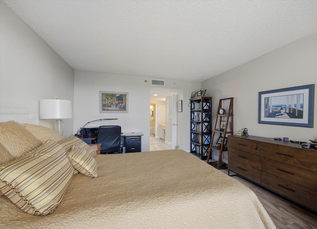 4101 N Ocean Blvd Unit D-308, Boca Raton, FL 33431 - bedroom featuring wood finished floors, a desk, and ensuite bath