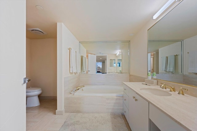 bathroom featuring tile patterned floors, toilet, tiled tub, and vanity