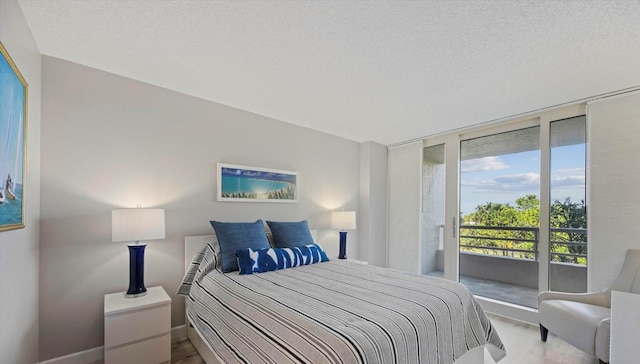 bedroom with a textured ceiling and access to outside