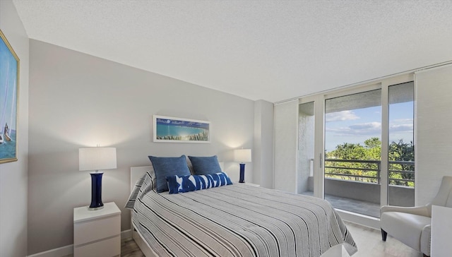 4101 N Ocean Blvd Unit D-308, Boca Raton, FL 33431 - bedroom featuring access to outside, floor to ceiling windows, and a textured ceiling