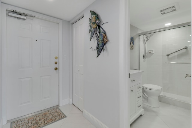 bathroom with tile patterned flooring, walk in shower, toilet, and vanity