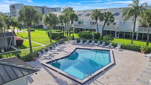 view of swimming pool with a patio and a lawn