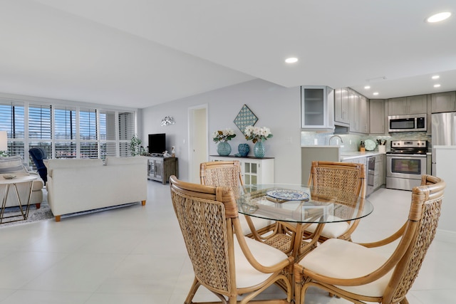 dining area with sink and light tile patterned floors