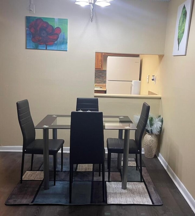 dining area with dark wood-type flooring