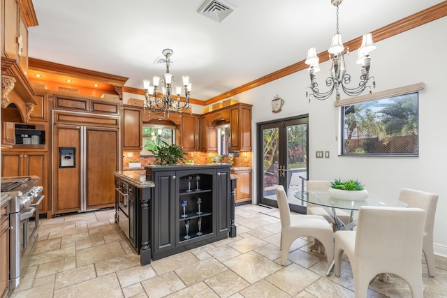 kitchen featuring french doors, tasteful backsplash, high quality appliances, a kitchen island, and ornamental molding