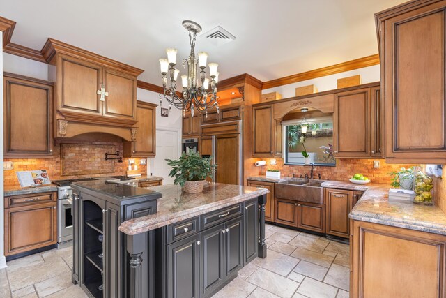 kitchen featuring a center island, high end appliances, an inviting chandelier, crown molding, and light stone counters