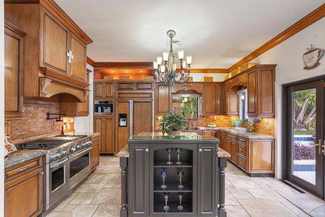 kitchen with pendant lighting, a center island, high end appliances, an inviting chandelier, and ornamental molding