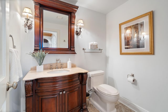 bathroom featuring tile patterned floors, vanity, and toilet