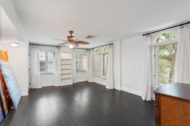 unfurnished living room with dark hardwood / wood-style flooring, plenty of natural light, and ceiling fan