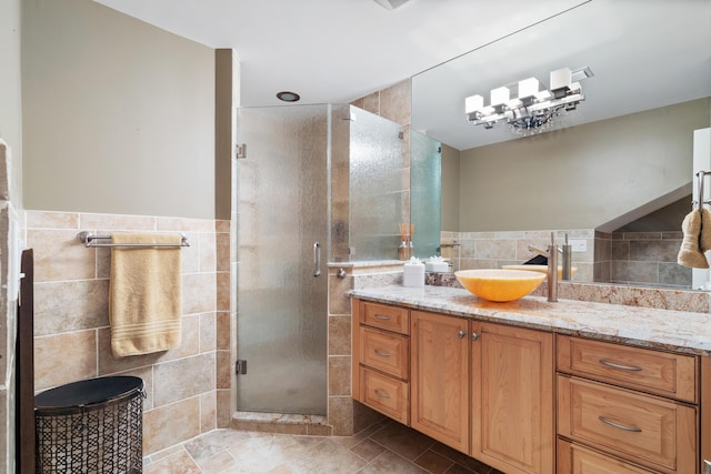 bathroom featuring vanity, tile walls, and walk in shower