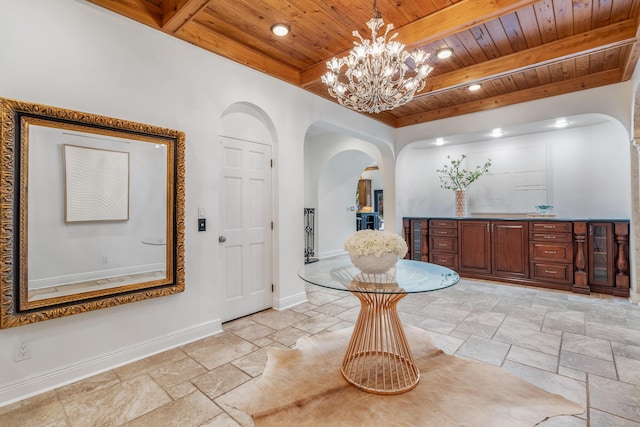 entrance foyer featuring beamed ceiling, wood ceiling, and a notable chandelier