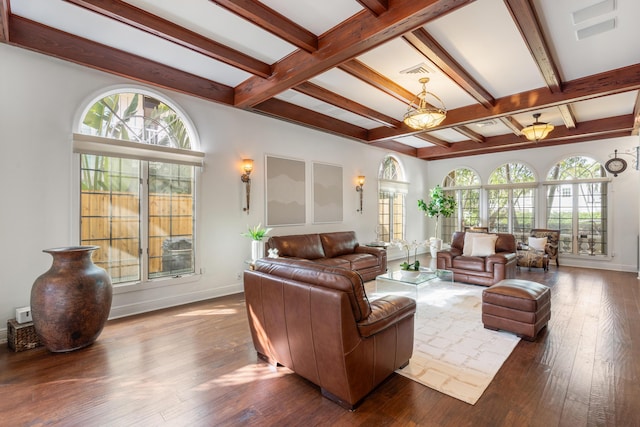 living room with hardwood / wood-style floors, a healthy amount of sunlight, and beamed ceiling