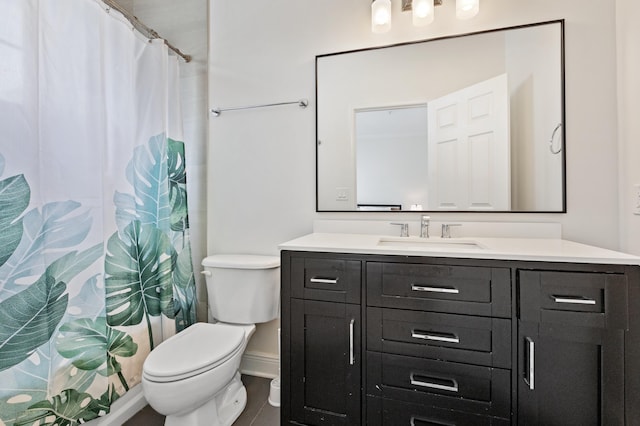 bathroom featuring toilet and vanity