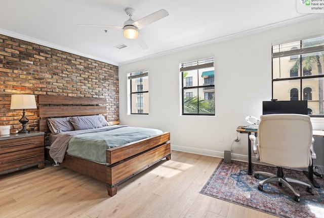 bedroom with light wood-type flooring, crown molding, and brick wall