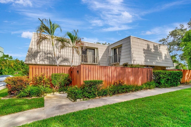 view of side of home featuring a lawn