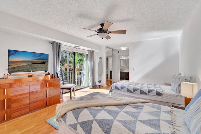 bedroom featuring ceiling fan, a textured ceiling, access to exterior, light wood-type flooring, and ensuite bath