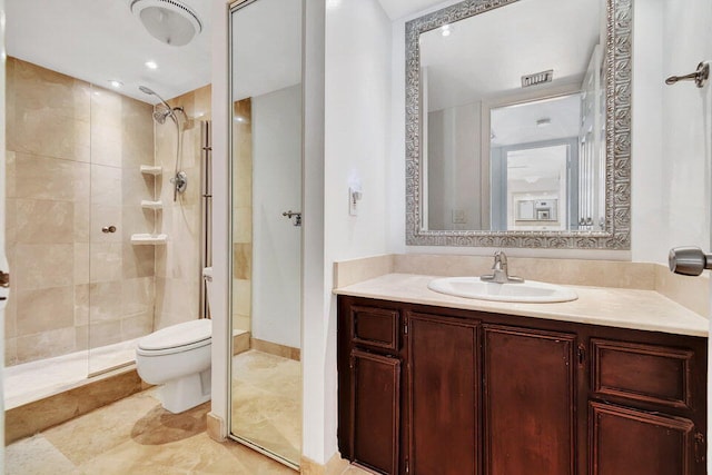 bathroom with vanity, toilet, and a shower with shower door