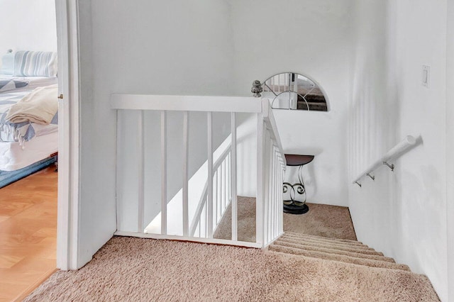 staircase featuring wood-type flooring