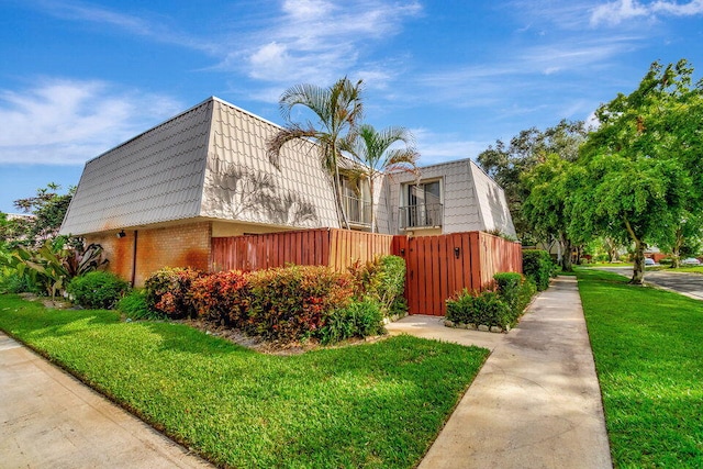 view of home's exterior with a lawn