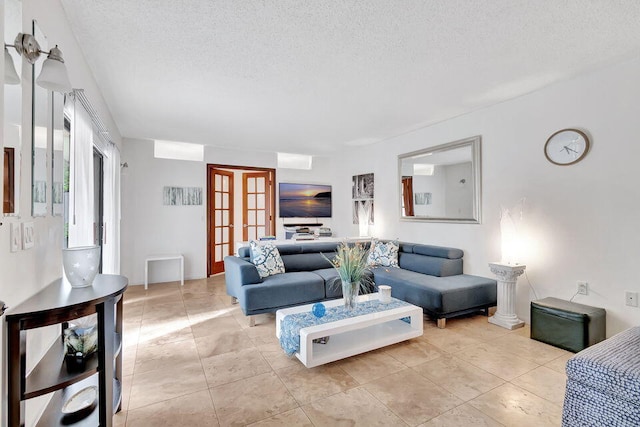 living room featuring a textured ceiling and light tile patterned floors