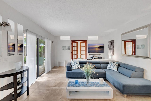 tiled living room featuring french doors and a textured ceiling