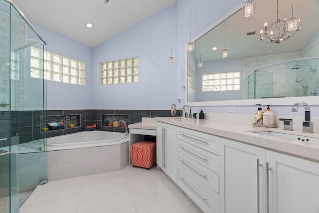 bathroom featuring vanity, a notable chandelier, shower with separate bathtub, and vaulted ceiling