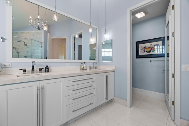 bathroom featuring a shower with door, vanity, and an inviting chandelier