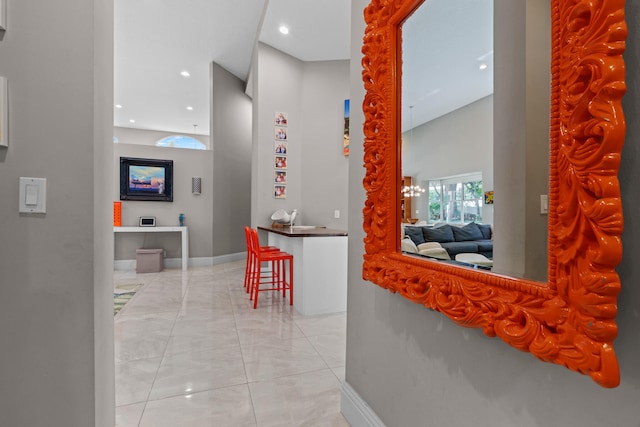 hallway featuring an inviting chandelier