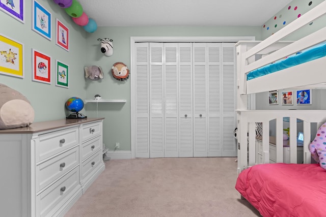 bedroom with a closet and light carpet