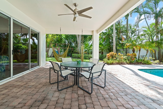 view of patio / terrace featuring a fenced in pool and ceiling fan