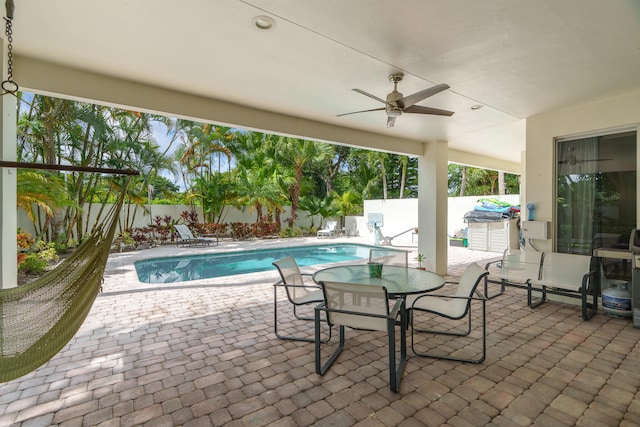 view of swimming pool featuring a patio area and ceiling fan