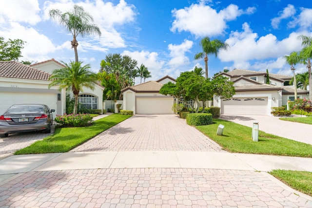 view of front of home featuring a garage and a front lawn